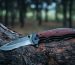 Tactical knife survival and protection difficult conditions, lies trunk tree in forest